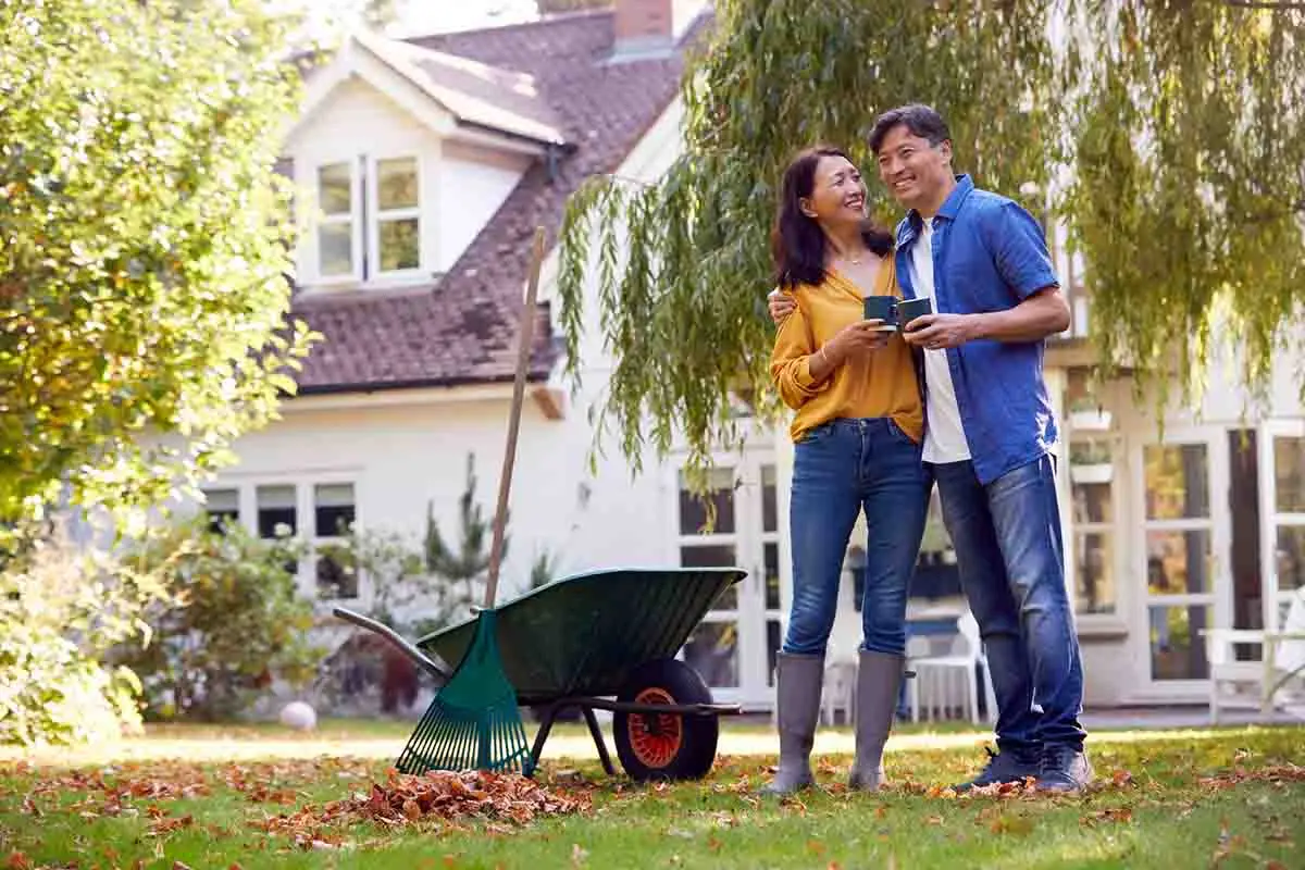 mature couple in yard taking a break from during yardwork