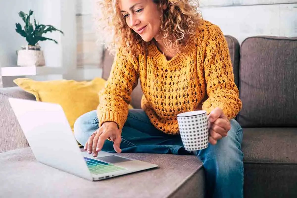 woman on couch with laptop learning about investing