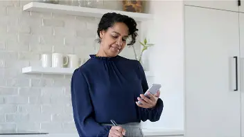 Individual comparing savings account rates on a smartphone