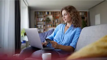 Person opening a savings account online using a laptop
