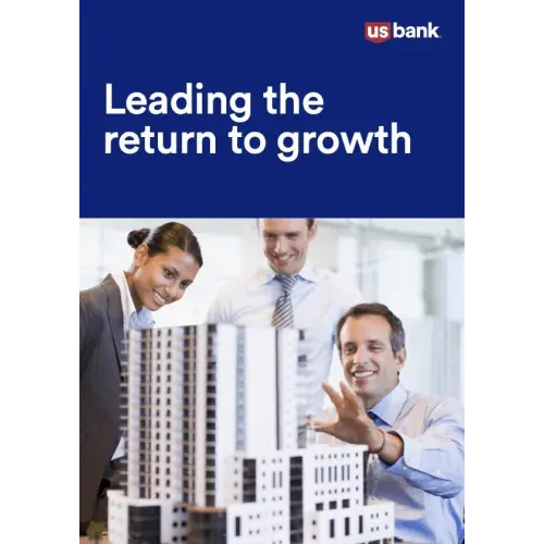 Three professional colleagues looking at a model of a high-rise building
