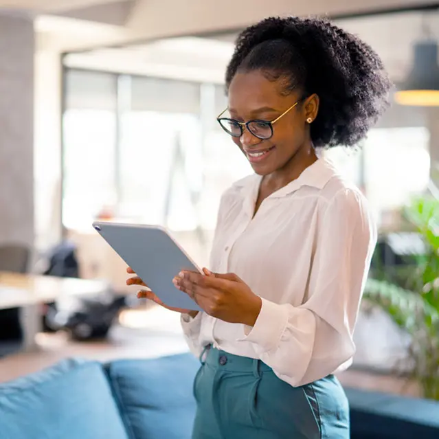 Young woman using an iPad to invest