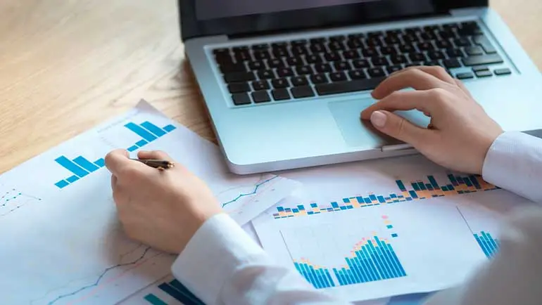 Hands typing on laptop