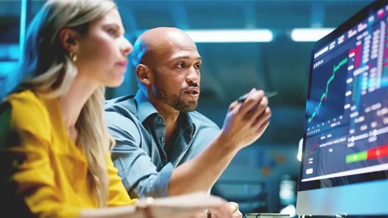 Business people, computer screen and finance graphs on screen