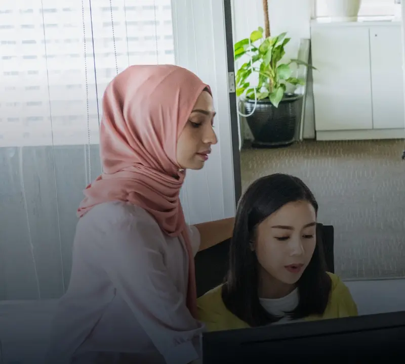 Two young women working in an office