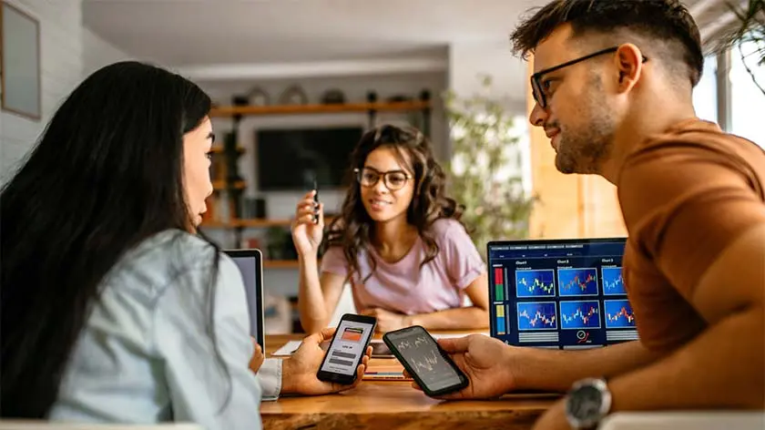 young investors using smart phones to invest in cryptocurrency