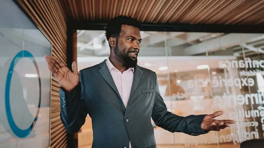 Executive giving a presentation about social engineering fraud risk management strategy.