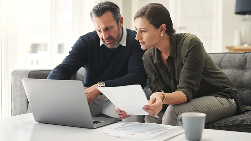 middle aged couple checking their finances online