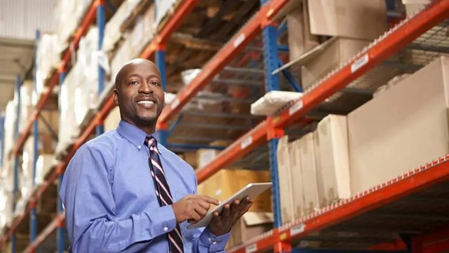 Man wearing a tie standing in a warehouse