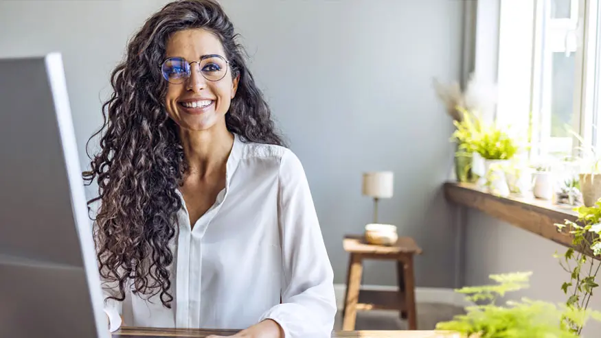 young artist smiling in front of her easel
